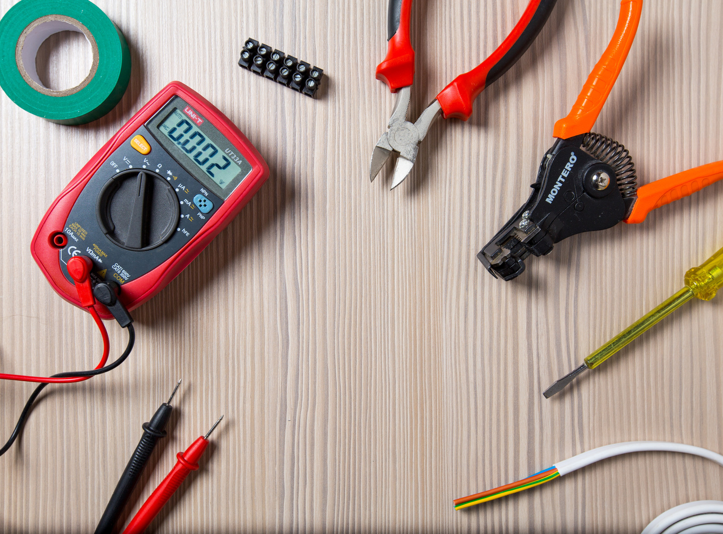 Electrician Tools on Wooden Background